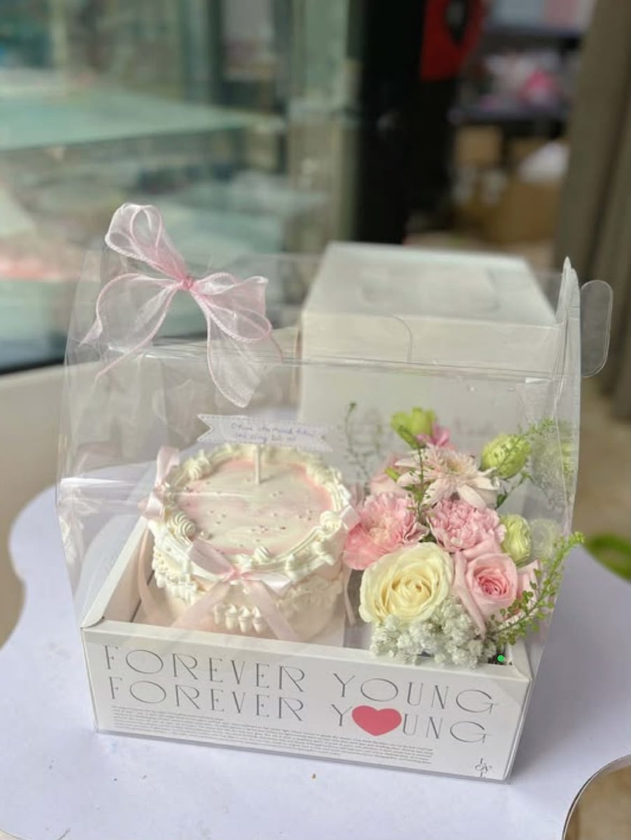 Vintage mini cake beside a fresh flower bouquet box